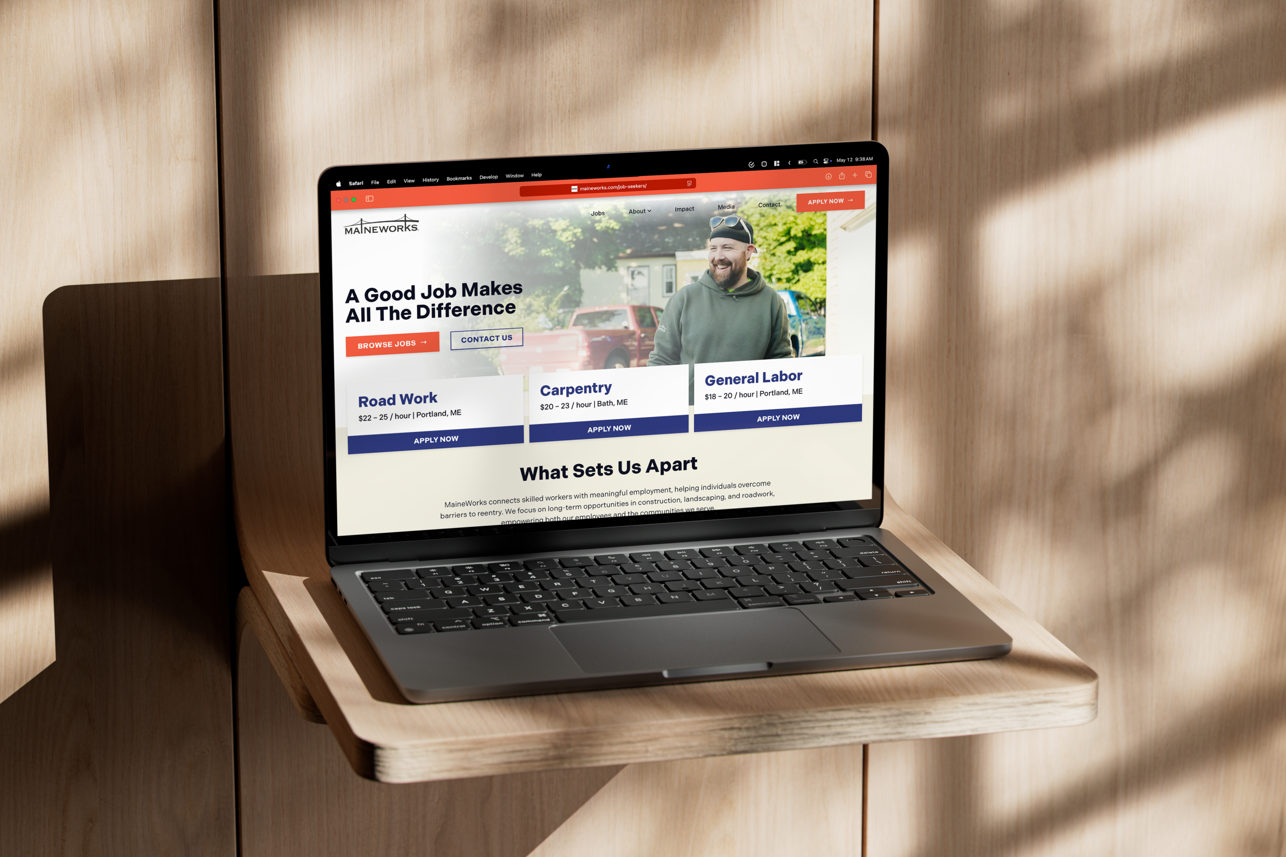 the MaineWorks website displayed on a laptop on a wooden background